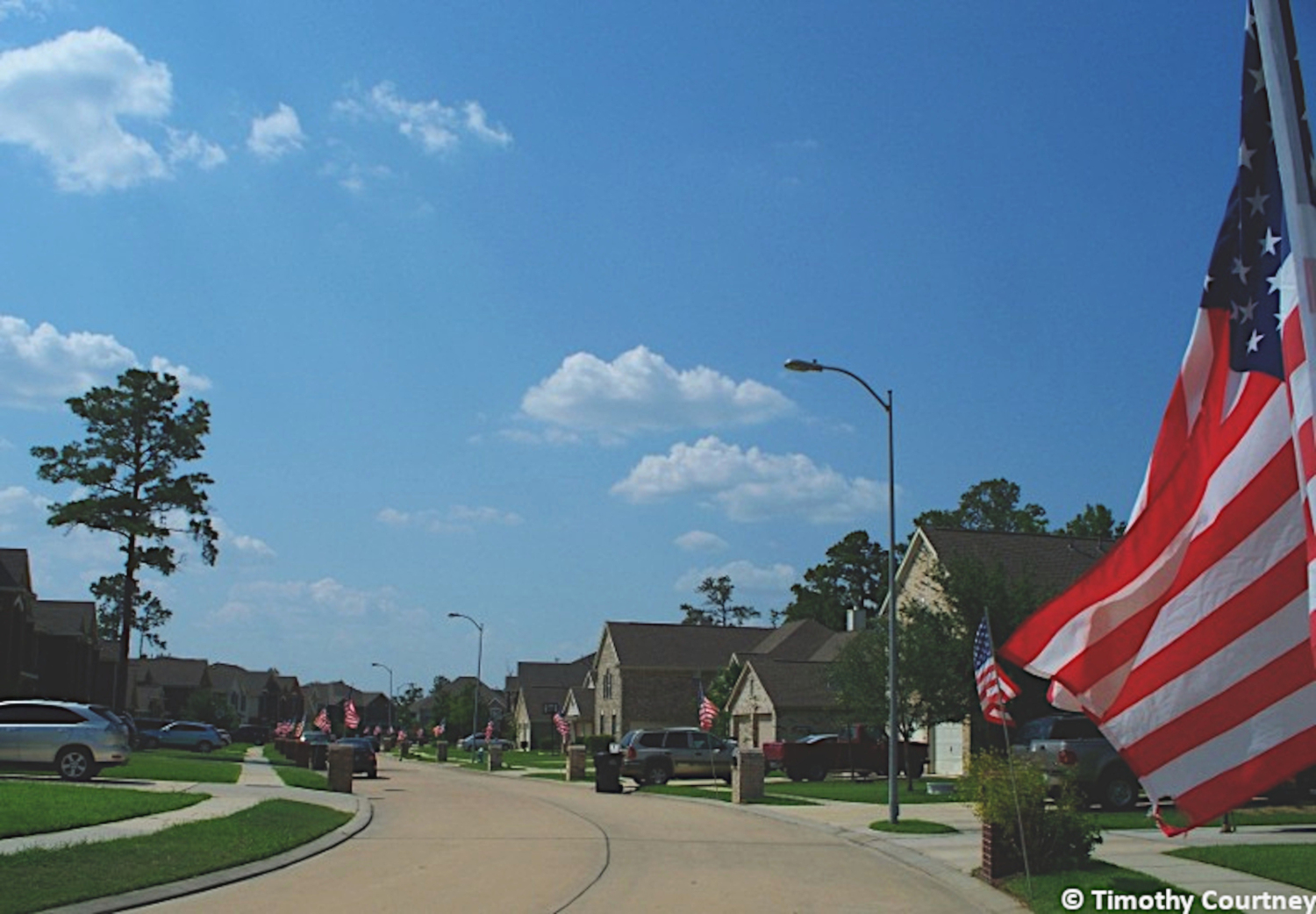 This patriotic street in Texas displays American Flags for the Holiday