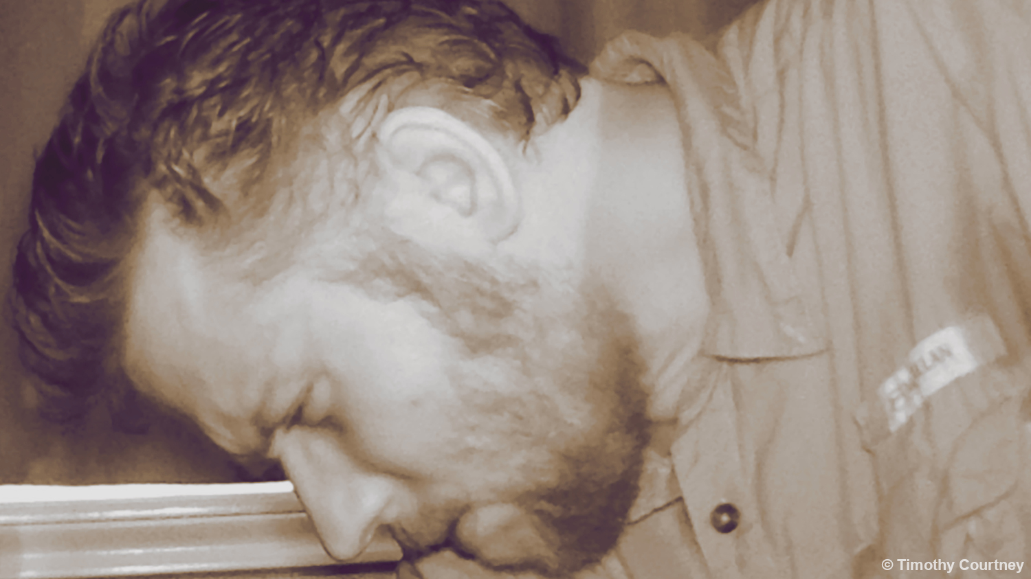 Closeup photo of Timothy Courtney with a beard and Magellan button up