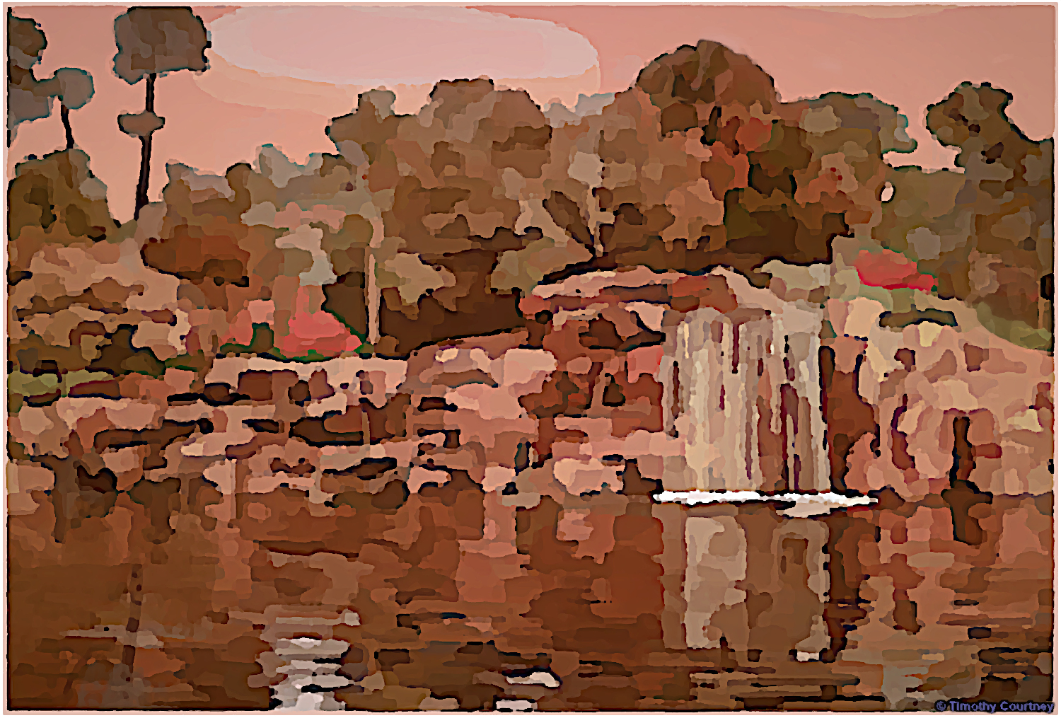 A beautiful scene full of Fall colors encasulate a waterfall flowing into a pond